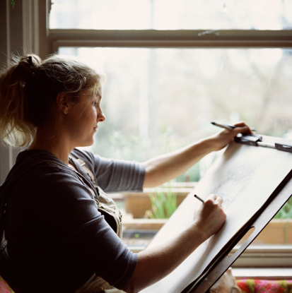 88165357 Woman Drawing On Easel Gettyimages